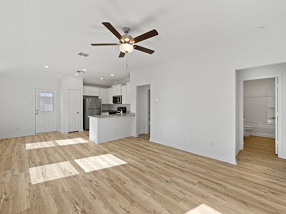 A spacious family room and adjoining kitchen