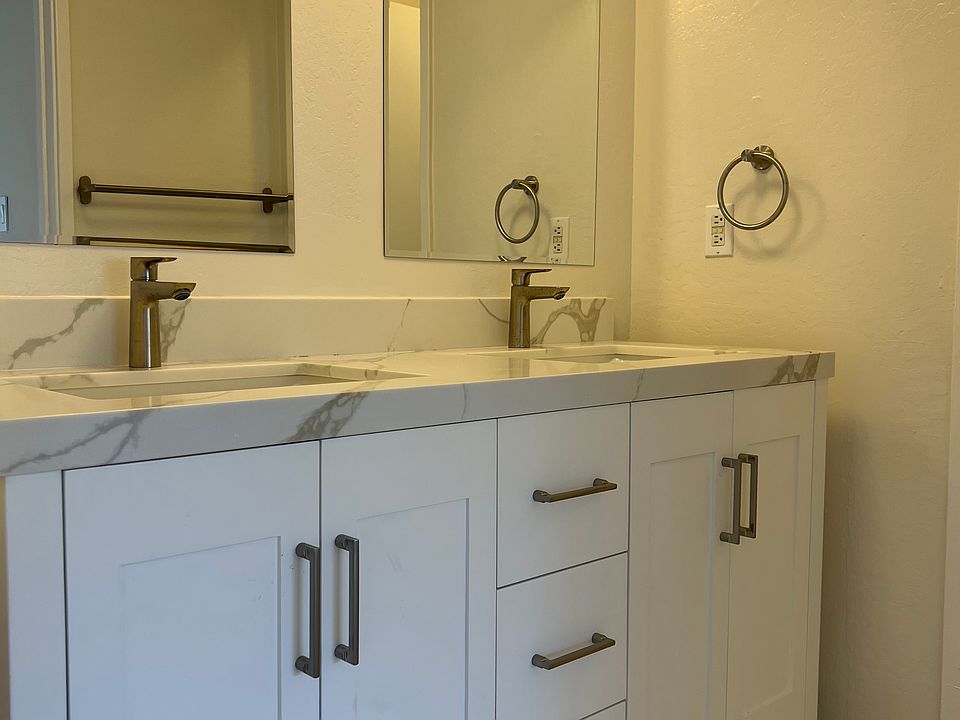 Remodeled bathroom with new vanity, faucets mirrors, lights and flooring.