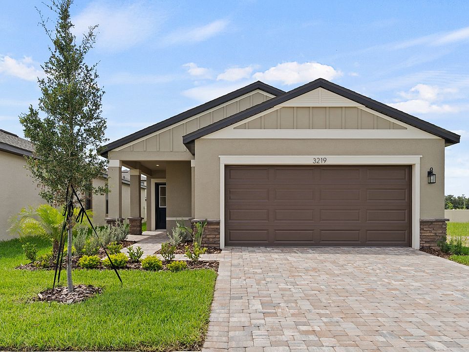 The Flagler at Grasslands West in Lakeland, FL offers a paver driveway, 2-car garage, and manicured