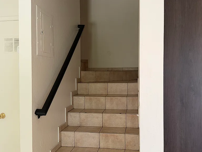 Stairwell to 3 Upstairs Bedrooms and Bathroom with Tub and Shower