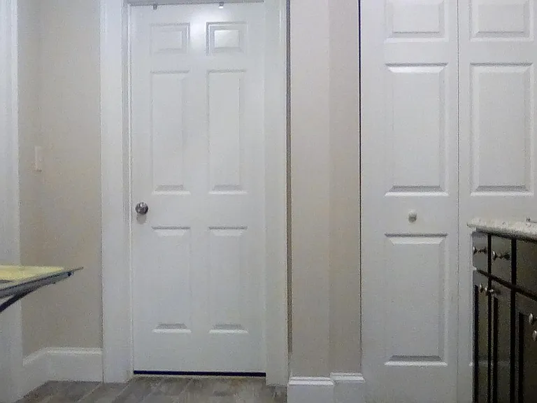 Left door to bedroom, center door to bathroom, right door is pantry door