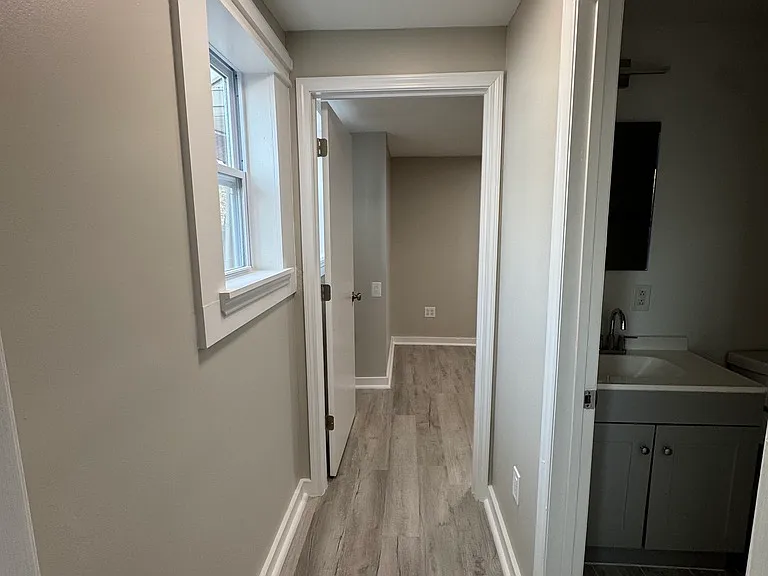 Hallway with entrance to bathroom and bedroom