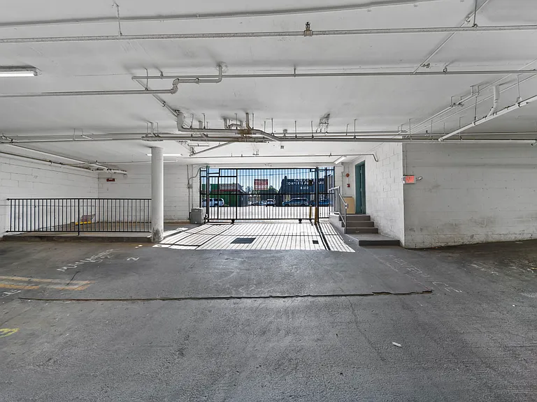 Spacious gated parking garage offering covered parking and controlled access.