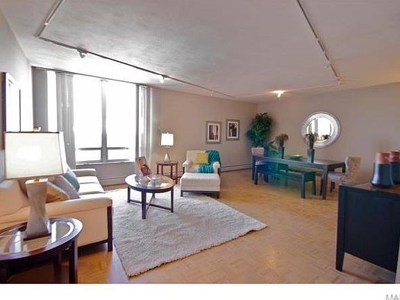 A dining room table seating six easily fits in the living room.