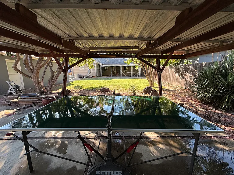 Outdoor ping pong table under pergola in back yard!