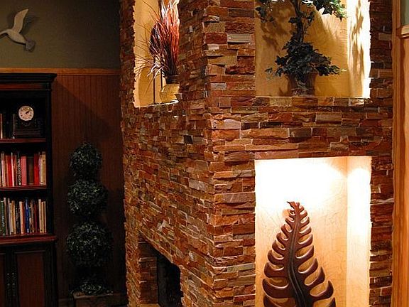 new stacked stone fireplace with lighted niches