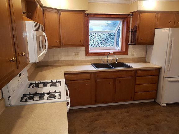 Kitchen includes "Over-The-Range" Microwave, oven, refrigerator with icemaker, & dishwasher. Also includes two bay windows, solid surface wink, and LED lighting. Also includes vinyl plank flooring, tile backsplash, & crown molding.