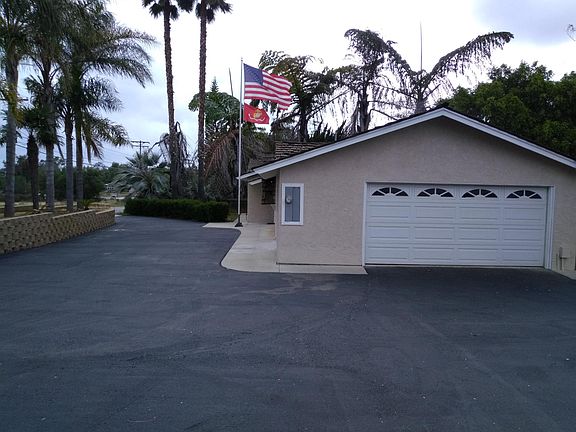 Front half of horseshoe driveway and landscaping. 