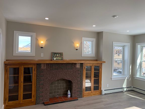 Can celling lights, many windows and the light sconces light up the living room
