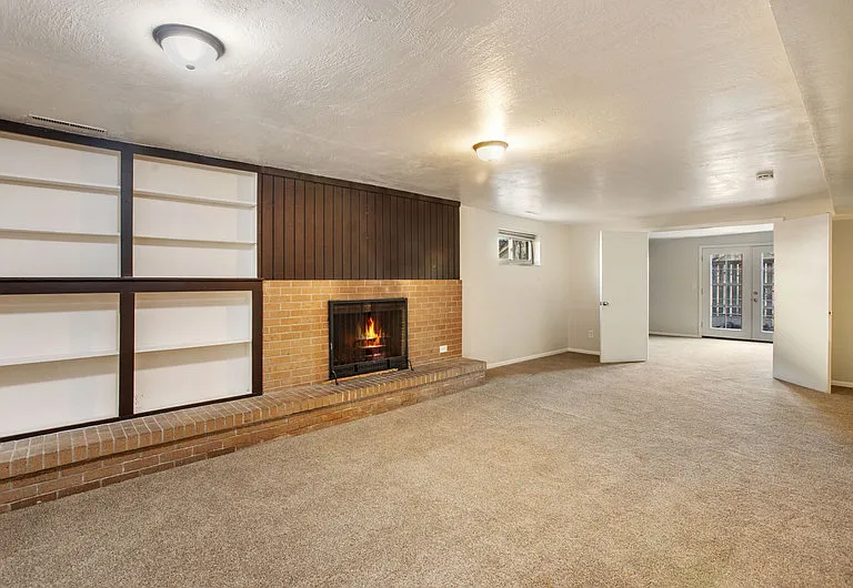 Basement living room and bonus room leading to patio