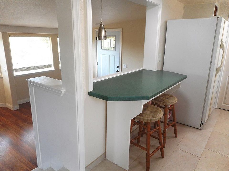 Kitchen with tile flooring. Dine in countertop looks out to the views.