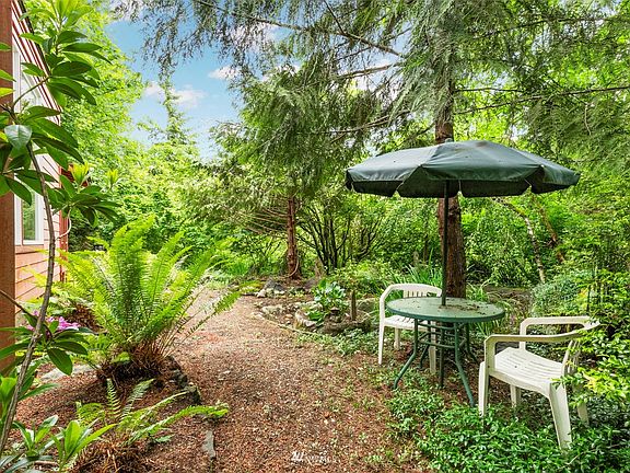 Plenty of space to relax in the garden.  Re-work the pond for the soothing sound of running water.>