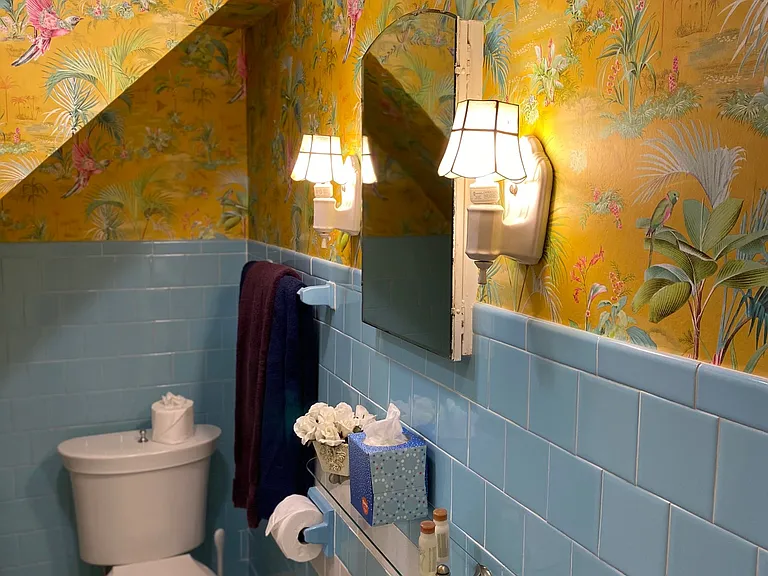 Full dedicated bathroom in the third bedroom. Original restored tile and cast-iron tub/shower.