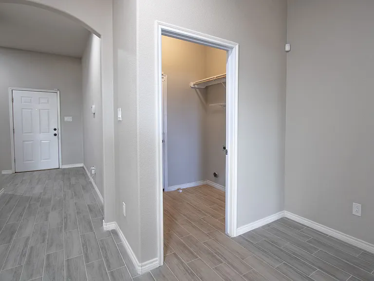 Living room looking into the entry to the laundry room and entrance to the garage
