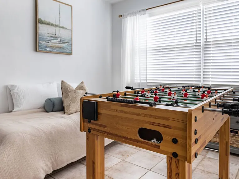 Single bed and foosball table.