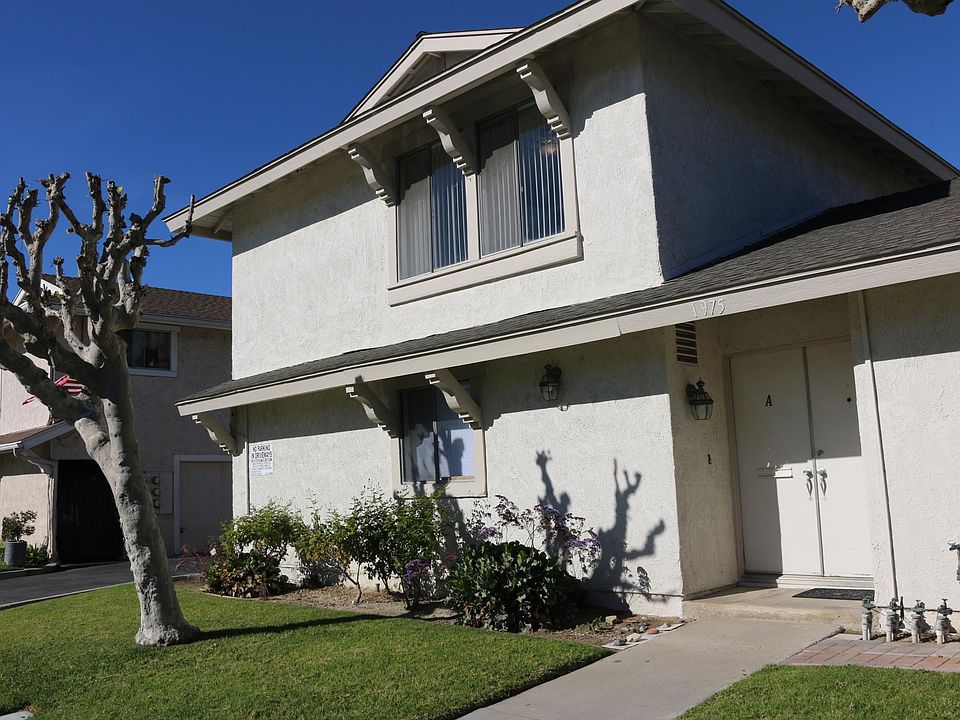 FRONT OF 3BR TWO STORY. TREES ARE NOW IN FULL BLOOM AND SHADED LAWN, DOUBLE GARAGE ATTACHED ON DRIVEWAY SIDE