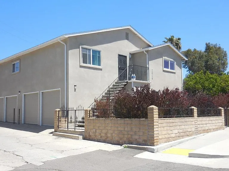 building, upstairs unit is above garages using the private stairs