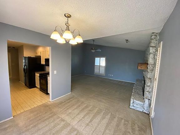 View from dining room into living room and kitchen.