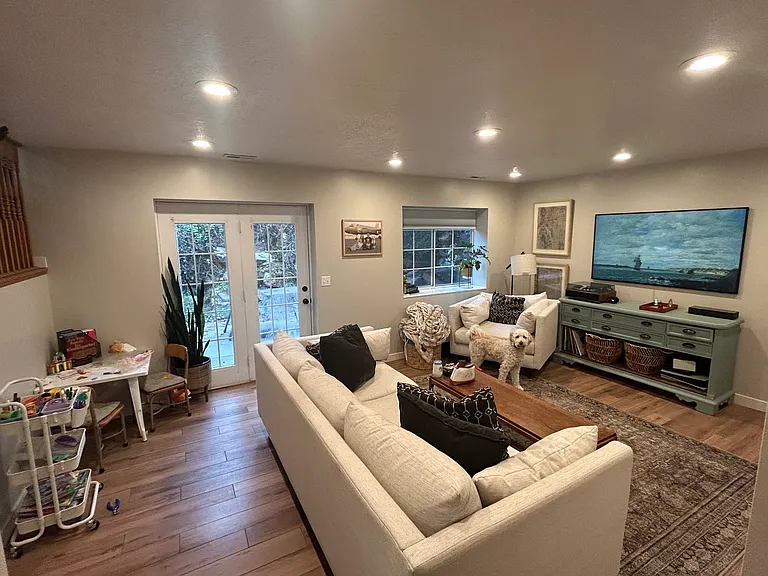 Living room with two-section patio doors into the backyard.