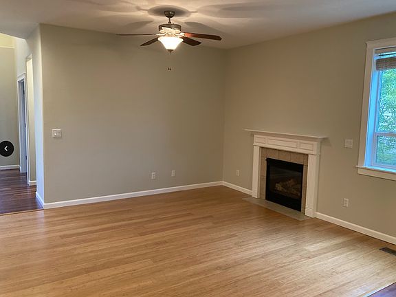 Living room as seen from kitchen; entry hall is on the left in the photo. Fireplace is propane; tenant pays propane bill.