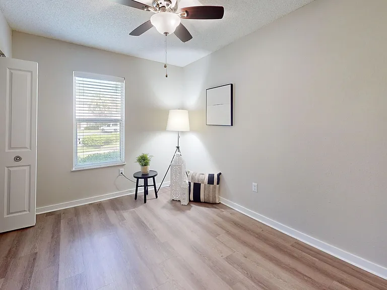 Experience comfort in the Jekyll guest bedroom featuring a lighted ceiling fan and thoughtfully designed closet space for your convenience.