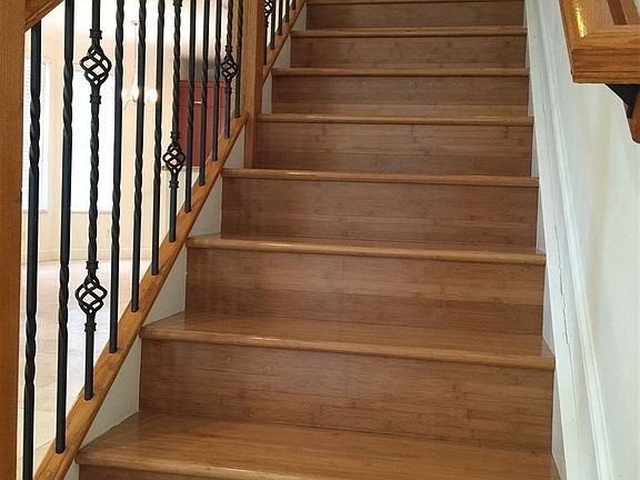Elegant wood and cast iron railing, pine wood stairs and hal