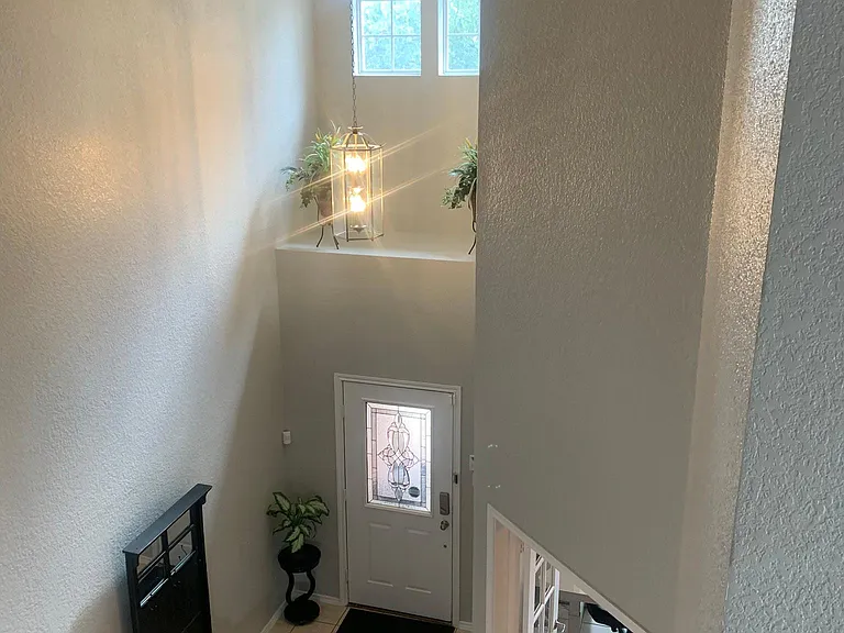 View from loft area to front door and office.