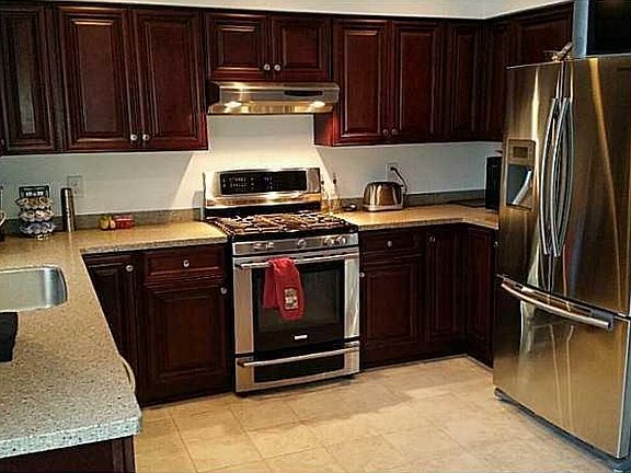Maple kitchen, stainless appliances, Corian solid surface co