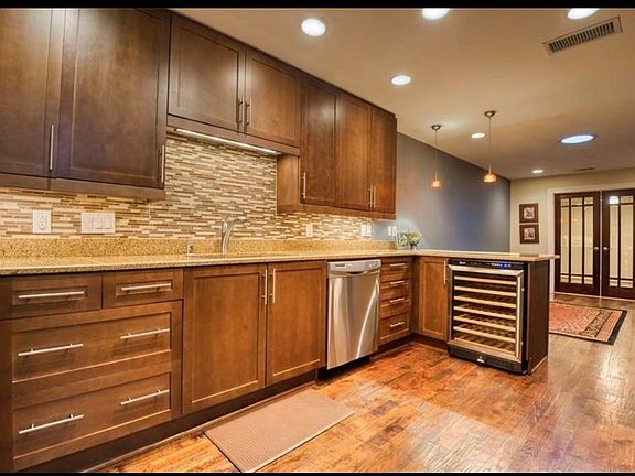 Absolutely Beautiful kitchen that was recently remodeled with wine cooler that also serves as a small counter bar. Cabinets go to the ceiling and recessed lighting.