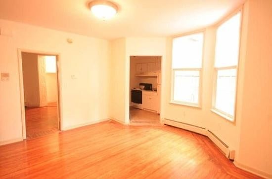 Living room with bedroom on the left and kitchen on the righ