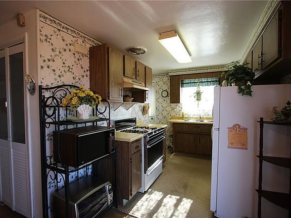 Another Deep Pantry outside of 10x8 Kitchen w/ Plenty of Cabinets & Back Door to Side Deck