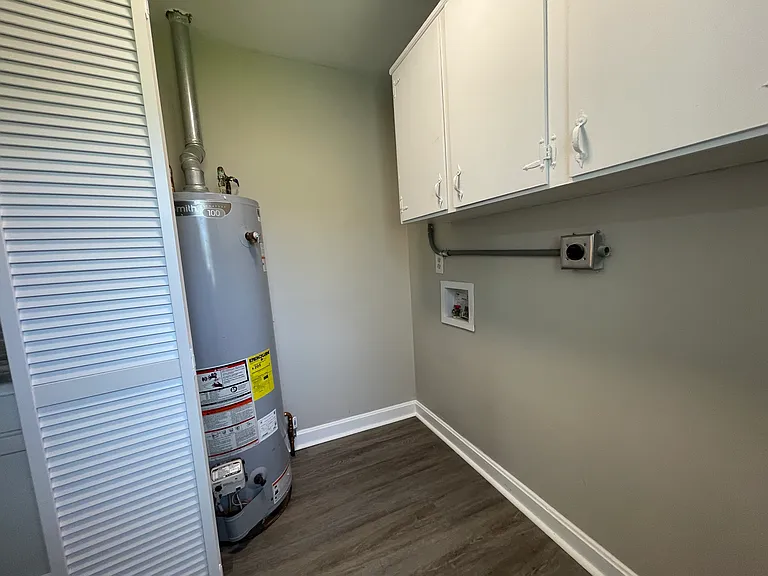 Utility room with upper cabinet storage. And washer/dryer hookup