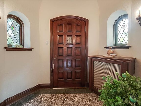 Gracious entry with tessellated terrazzo floor, 2 beautiful stained glass windows.