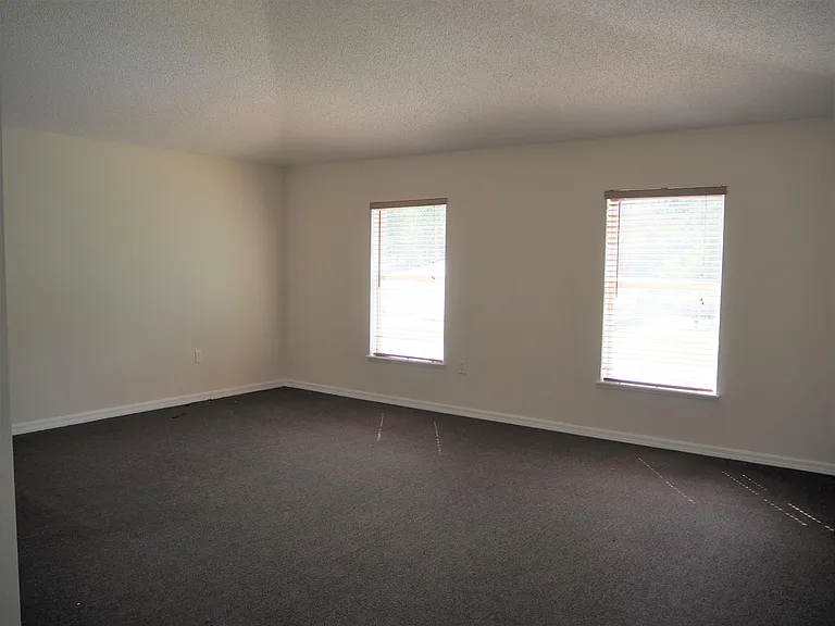 Master bedroom with vaulted ceiling.