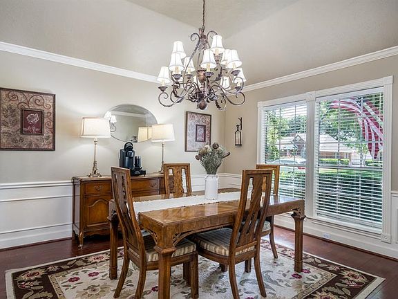 Fancy dinners in the formal dining will be even more upscale because of the room's hardwoods, gorgeous updated chandelier, cove ceiling, crown and chair rail molding.