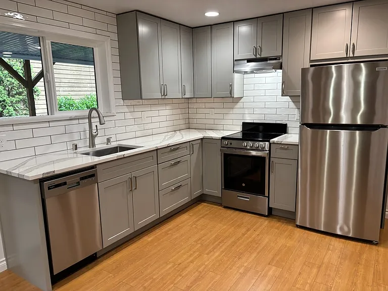 New kitchen with quartz countertops, cabinets with soft-close hinges, new electric range, new refrigerator with internal ice maker, and new dishwasher.