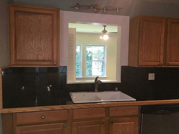 Upstairs kitchen with view of back sun room and forest!