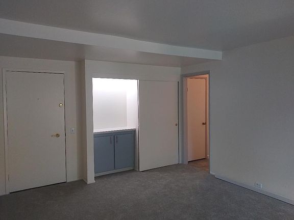 Living Room continues / Additional Storage Space - Lighted Bar Area