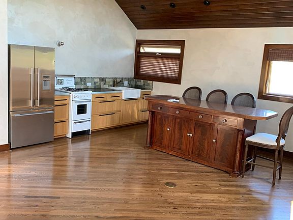 Skylight in kitchen refrigerator included kitchen island and 4 barstools
