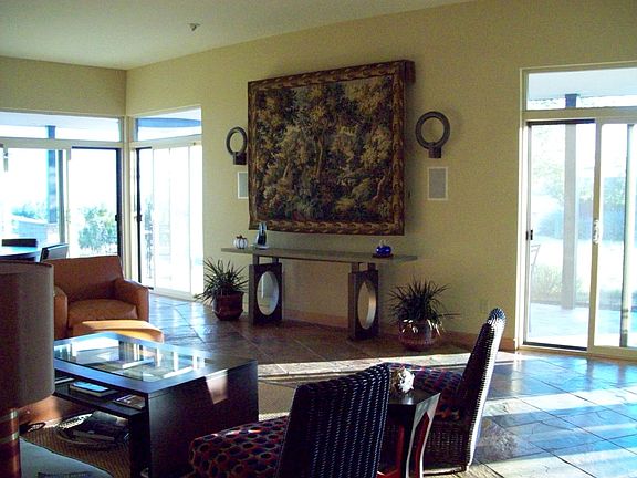 Entering living room with TV hidden under tapestry