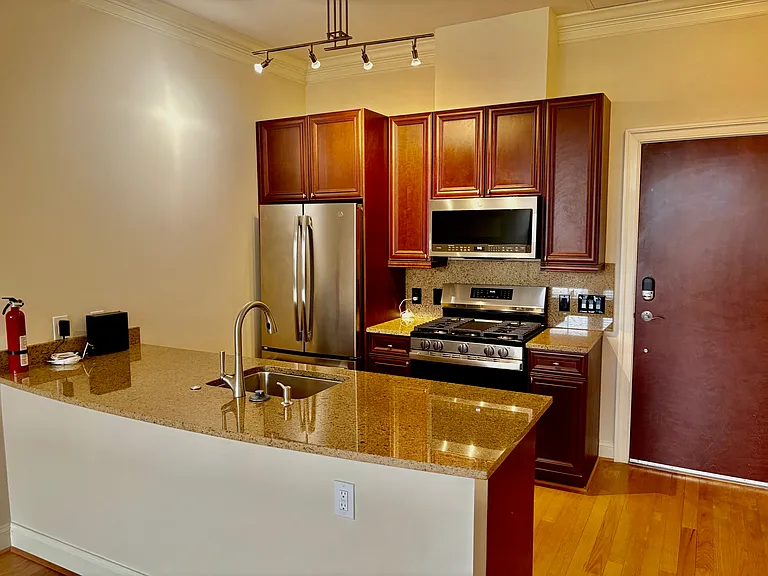 Kitchen w/ Bran New Stainless Steel Gas Range, Side by Side Refrigerator, Dishwasher and Over the Range Microwave.