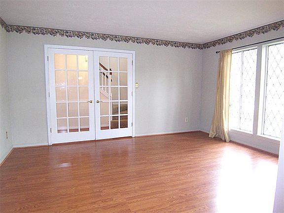Spacious with large window overlooking front yard and gleaming wood laminate floors!