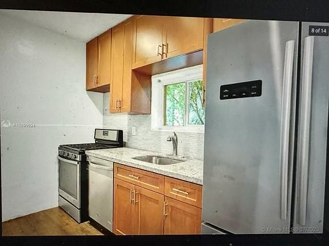 Kitchen with modern cabinetry and window of landscape view