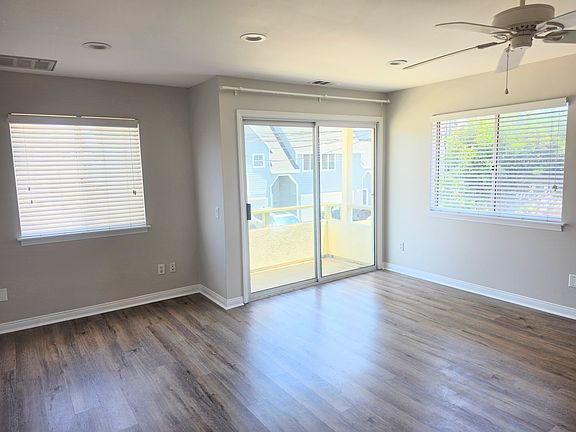 Living/dining area with windows/glass doors wrapping around.