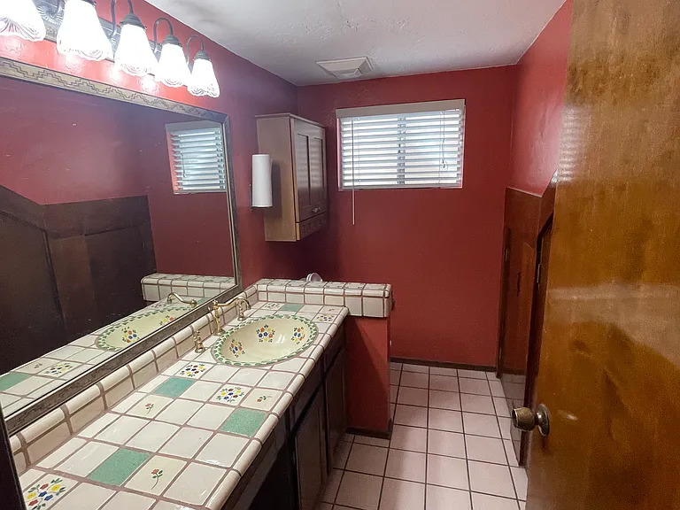 Main floor half bathroom with storage area