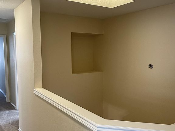 Top of stair well with art niche and skylight