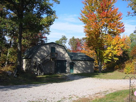 Barn with second story on the left side and the attached hanger on the right.
