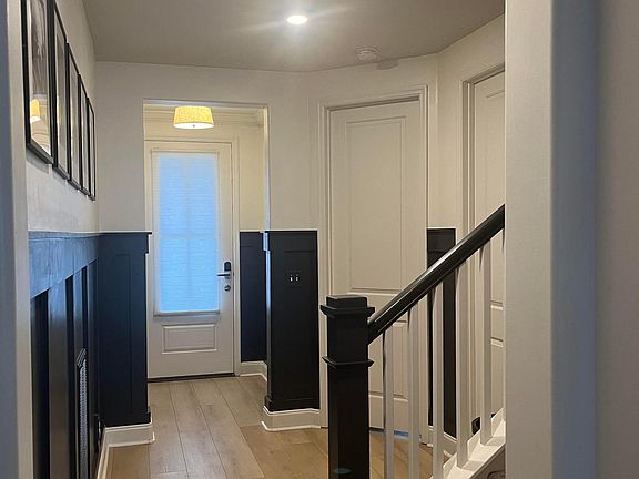 opposite view of front hallway with door to office and bathroom