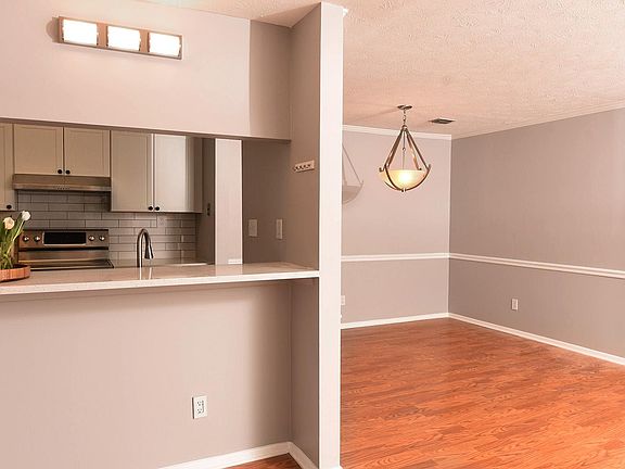 Kitchen, dining room and front door over to the right side of photo.