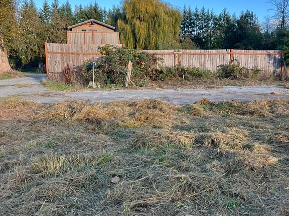 Looking east: 
The parking space is just in front of the fence. Wintertime.